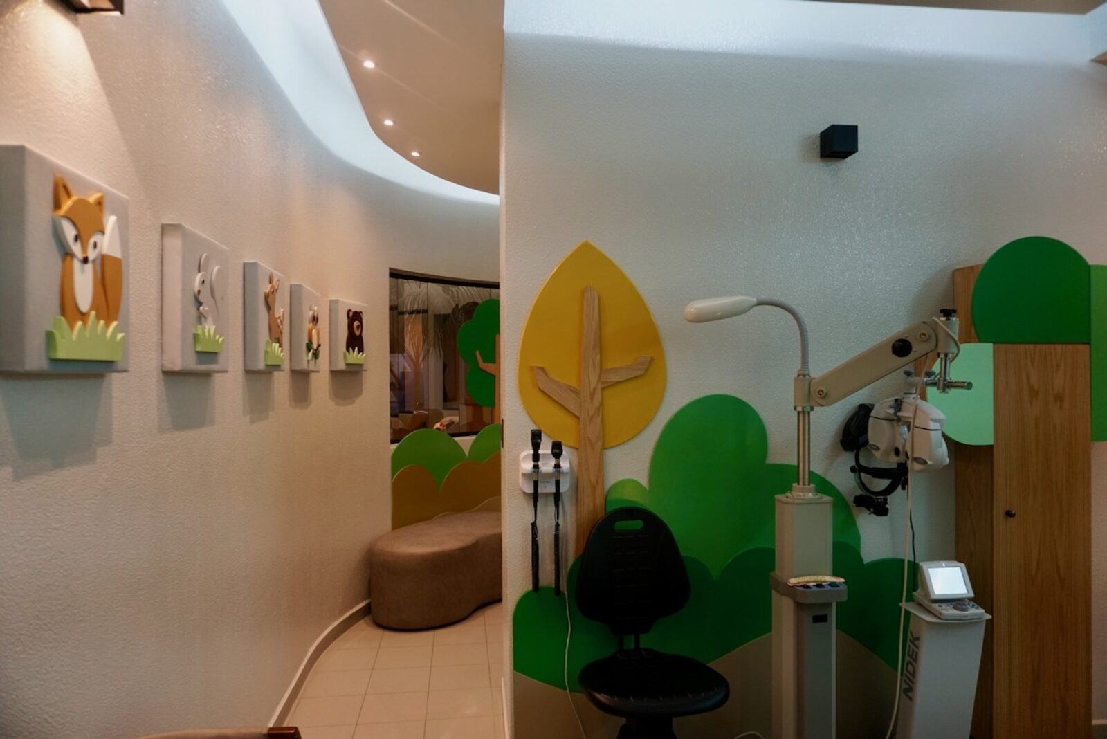 Hallway decorated with forest animals leading to the examination area